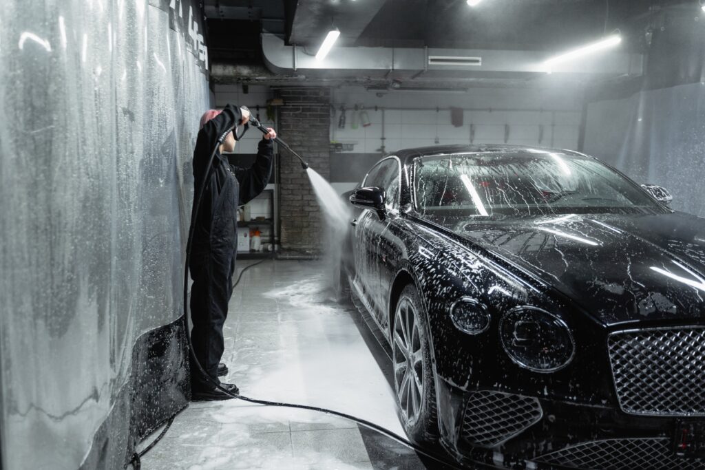 Man cleaning bentley after increasing horsepower