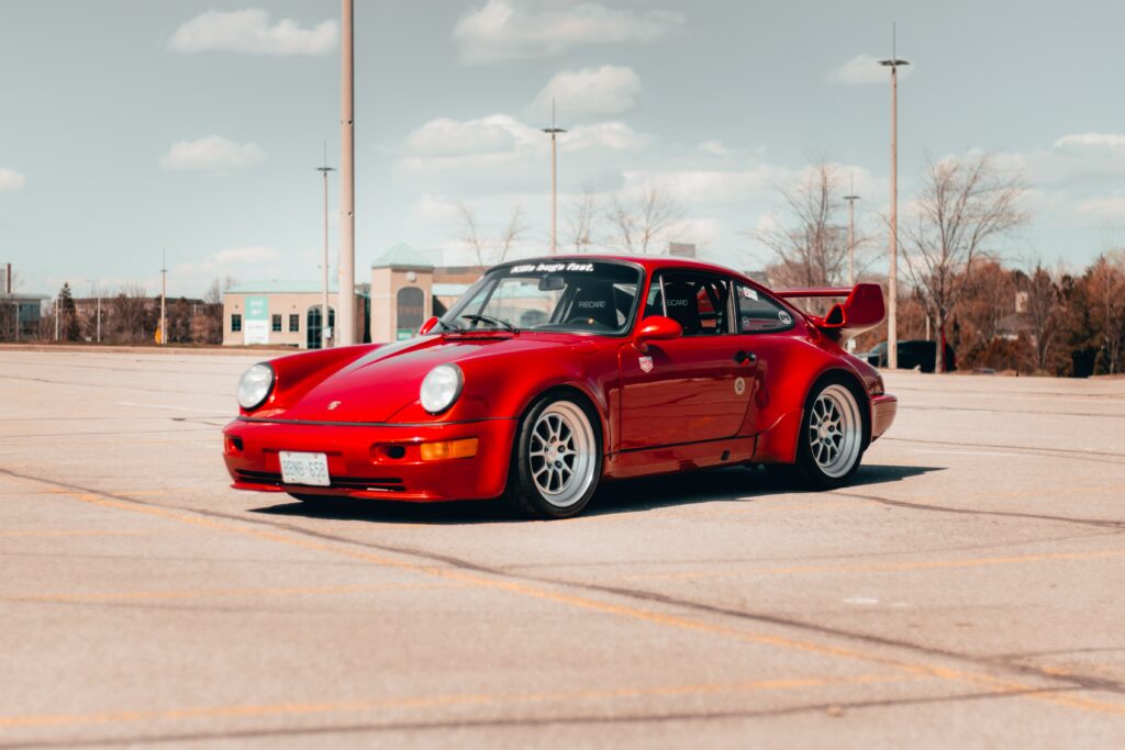 red modded porsche 911 with spoiler and aftermarket wheels 