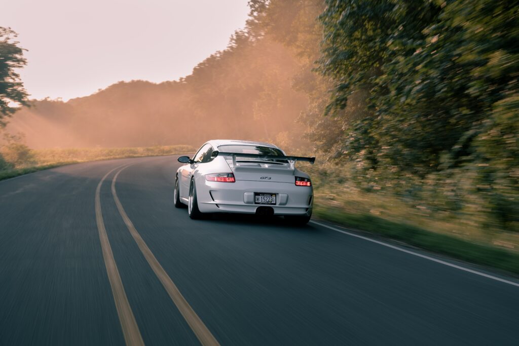 white porsche 911 modded with aftermarket wheels